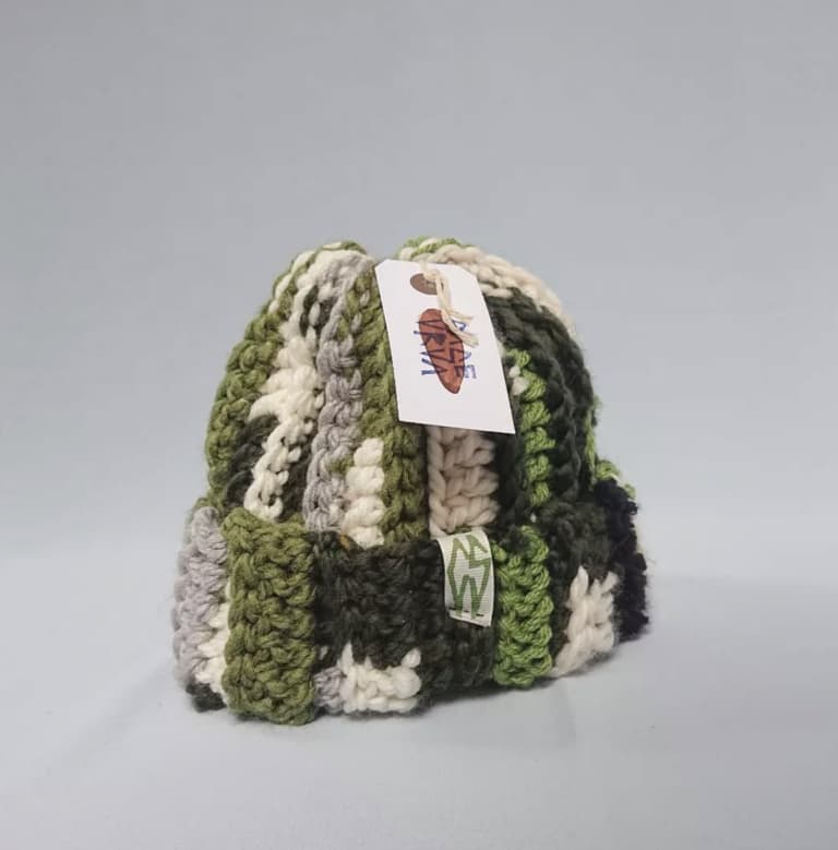 Staged photo of a multi-colored green scrappy hat from Carsea